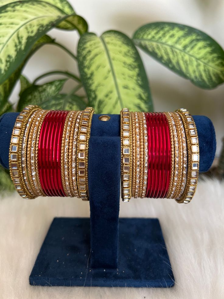 red    Bangles with Kundan Detailing. These stylish bangles are made from copper and feature Kundan  stones.  Features: - Made from copper  - red   - Artificial  Kundan detailing  - Available in size 2.6,2.8,2.10 Red Bangles Set Bridal, Red Stone Work Bangle Jewelry, Red Ruby Bangle As Gift, Red Ruby Bracelet For Festive Occasions, Festive Red Ruby Bracelet, Red Stone Work Bracelets As A Gift, Red Bracelets With Stone Work For Gift, Elegant Red Bracelet With Stone Work, Elegant Red Bracelets With Stone Work