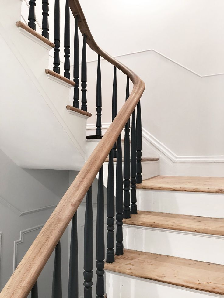 an image of a stair case with wood handrails