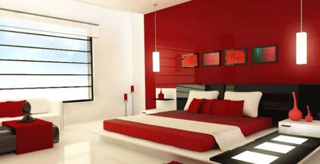 a red and white bedroom with a large bed