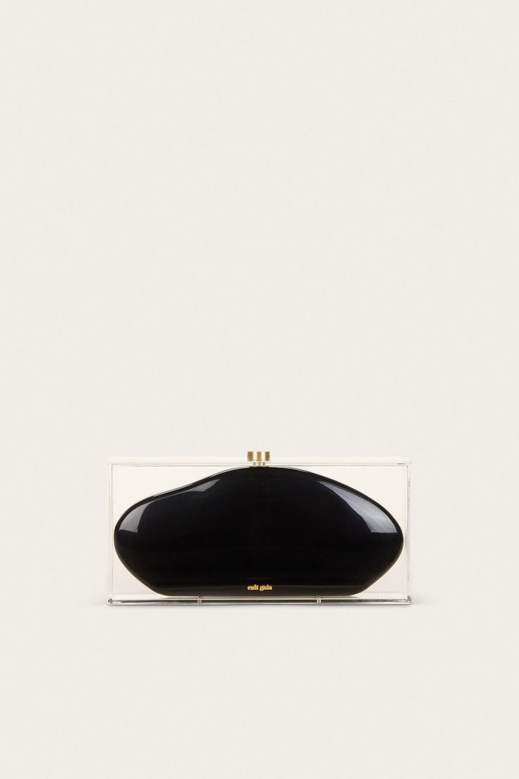 Taking a nod from 60’s mod glamour, the Annika Clutch is designed as a black curved clutch inside of a translucent box. The clear acrylic outside offers a very retro-inspired feel, and the black abstract-shaped middle casing creates a stark contrast. From weekend travels, to parties and galas — she’s sure to be an artful addition to any outing. Modern Black Rectangular Clutch, Black Rectangular Clutch For Parties, Modern Black Clutch For Formal Occasions, Black Rectangular Case Clutch For Party, Modern Black Formal Clutch, Chic Black Clutch With Rectangular Case, Modern Black Clutch For Evening, Chic Black Rectangular Clutch, Modern Black Clutch For Events