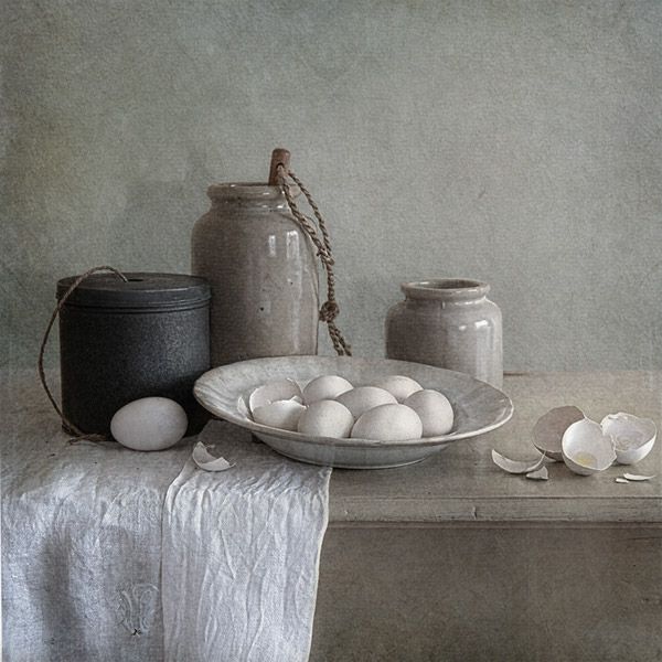 an image of eggs in a bowl on a table with other items around it,