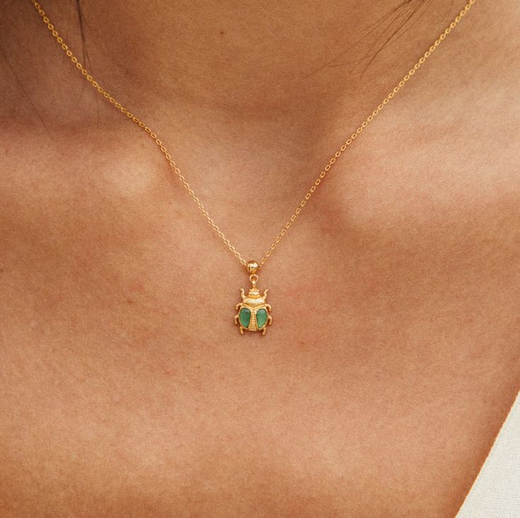 A symbol of grace and healing in ancient Egypt, beetles were believed to be protectors of good fortune to those in need. The green Aventurine amplifies its potency. Details: Ethically made in France in our Parisian workshop 2-year guarantee & water-resistant No risk of allergy (nickel-free, lead-free) Height : 9 mm (0.35") - Stones : Green Aventurine (stone color may vary slightly Charm + Chain Necklace Keywords : gift christmas fall winter summer spring mother day valentine hypoallergenic decor Green Jewelry For Good Luck, May Birthstone, Symbolic Green Jewelry For Good Luck, Grace Symbol, Green Aventurine Stone, Aventurine Stone, Charm Chain, Gold Gift, Beetles, Good Fortune