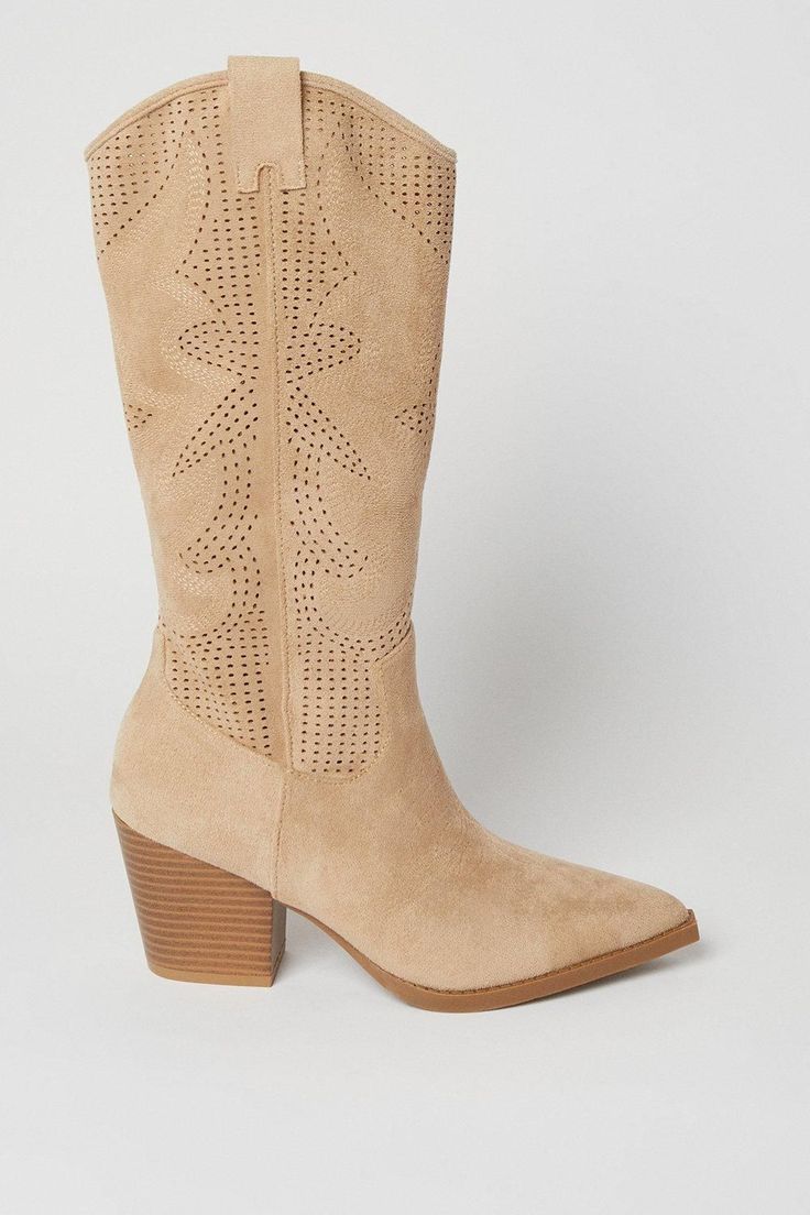 Western-inspired calf-length cowboy boots Intricate cutwork detailing for a feminine touch Mid-height heel between 5 and 6.5cm for comfortable wear Pointed toe design for a classic cowboy boot silhouette Faux leather construction for a cruelty-free option Step into the spotlight with these Jackson Cutwork Detail Western Calf Cowboy Boots from Oasis. These boots seamlessly blend classic Western style with contemporary flair, making them a versatile addition to your wardrobe. The intricate cutwork detailing adds a delicate, feminine touch to the robust cowboy boot silhouette. Perfect for transitioning from day to night, these boots can be dressed up or down with ease. Pair them with a flowing midi dress and denim jacket for a chic daytime look, or team them with skinny jeans and a silk blo Dress And Denim Jacket, Classic Cowboy, Oasis Fashion, Pierced Jewelry, Cowboy Boot, Boots Knee, Cut Work, Toe Designs, Western Style