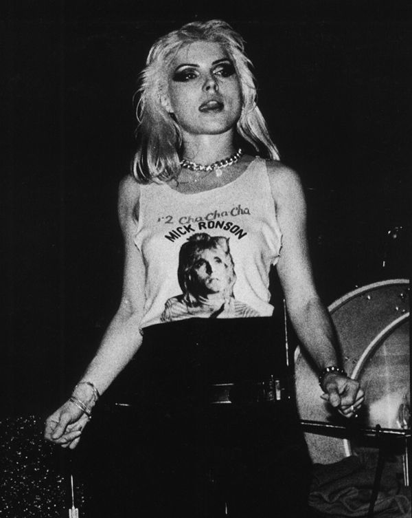 a black and white photo of a woman wearing a t - shirt with the image of marilyn monroe on it