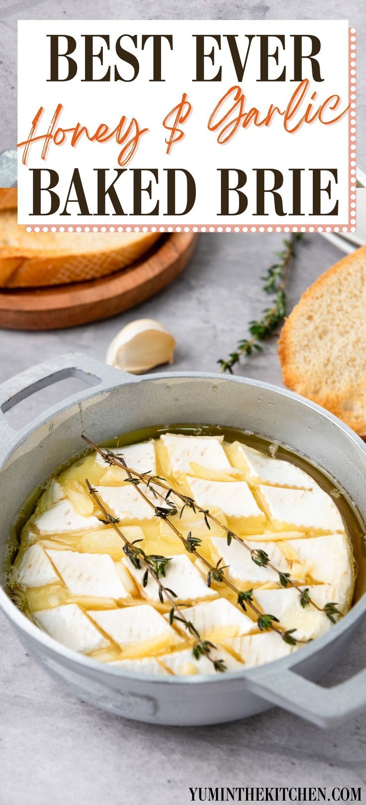 the best ever honey and garlic baked brie in a pan with bread on the side