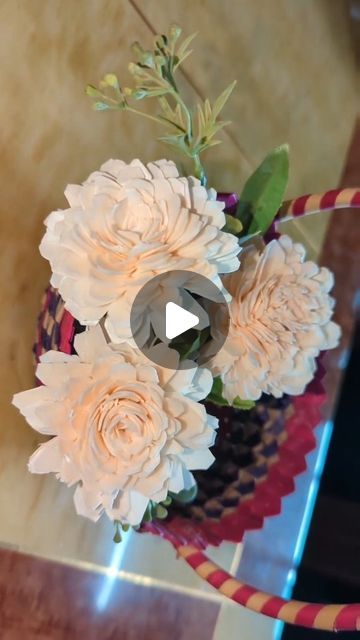 a vase filled with white flowers on top of a table