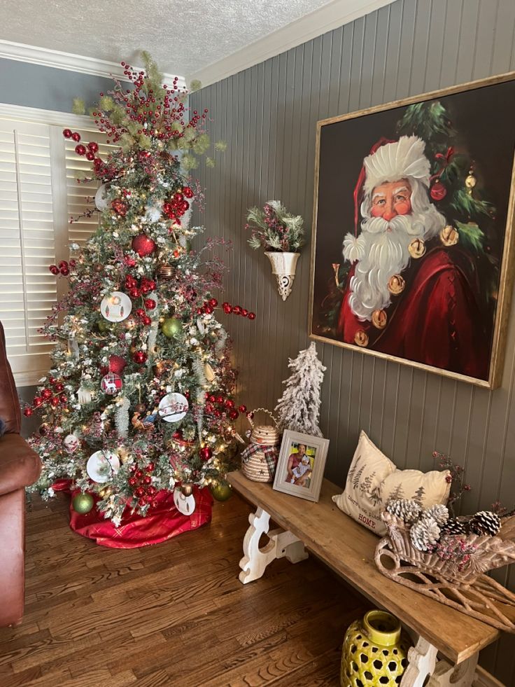 a living room with a christmas tree and pictures on the wall, along with other decorations