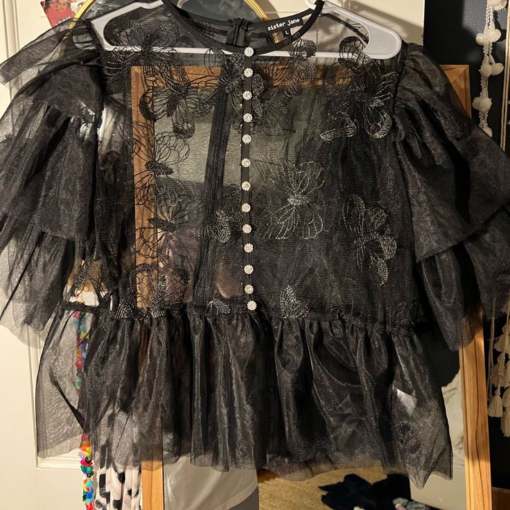 Reposhing Never Worn Just Don’t Need But Great Condition And Beautiful Shirt. Size L But The Oversized Look Looks Good With The Sheer!! Chic Black Sheer Shirt, Chic Sheer Party Shirt, Black Sheer Shirt For Night Out, Black Ruffled Shirt For Summer, Chic Black Ruffled Shirt, Black Ruffled Summer Shirt, Summer Black Ruffled Shirt, Chic Short Sleeve Party Shirt, Fall Black Sheer Blouse