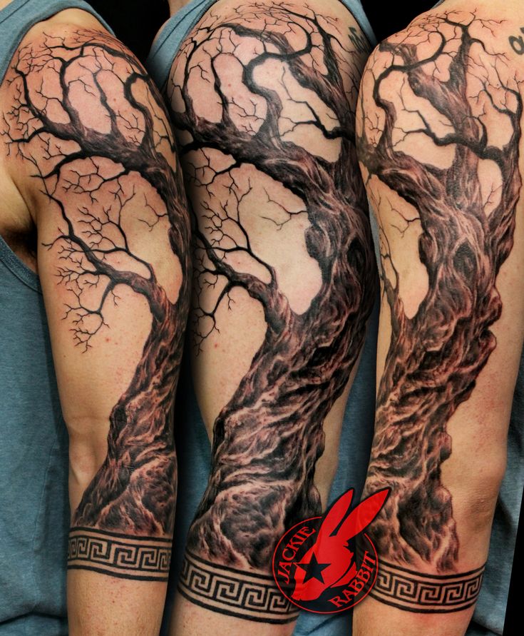 two men with tattoos on their arms, one has a tree and the other has a red bird