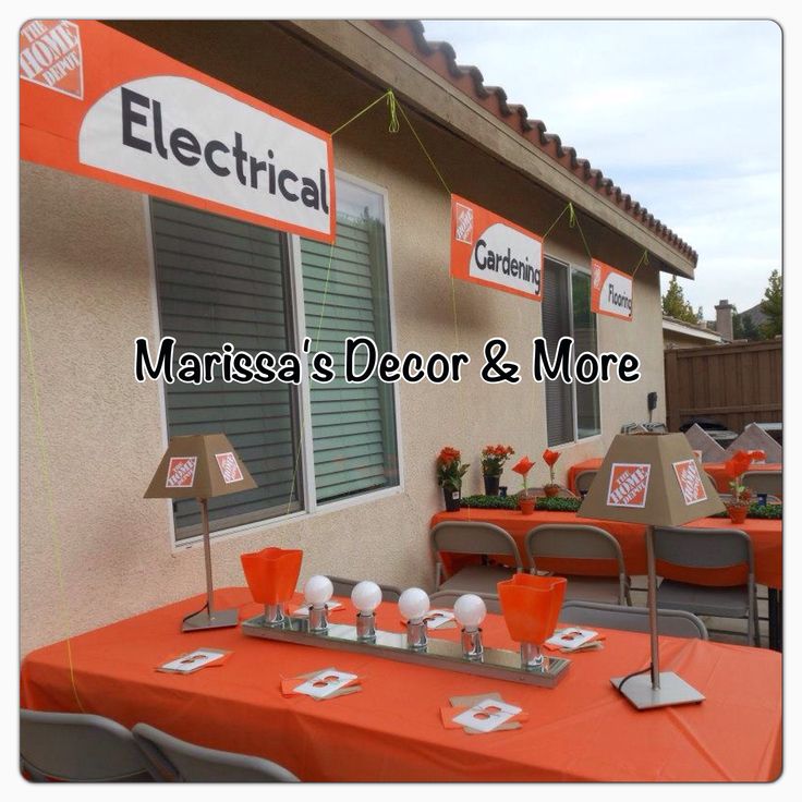 an orange table topped with cups and glasses next to a sign that reads electrical marquesa's decor & more