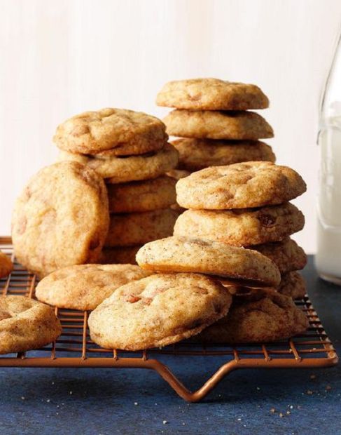 a pile of cookies sitting on top of a cooling rack