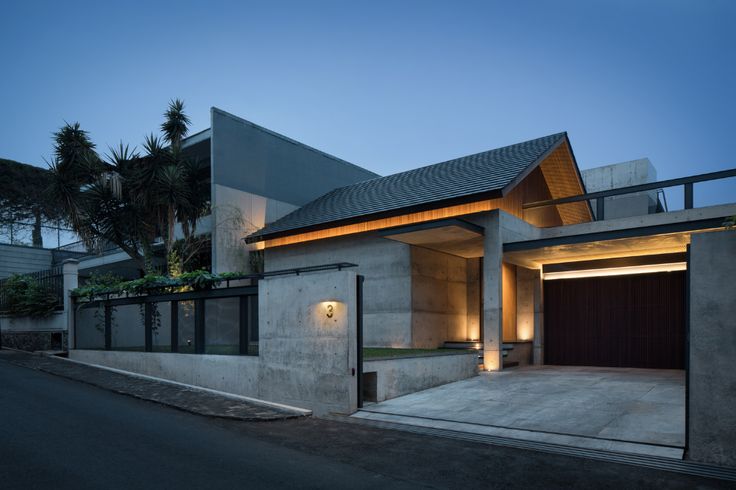 a modern house is lit up at night