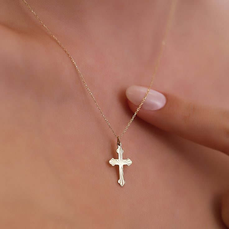 The dainty Cross Necklace, skillfully crafted in 14K Gold, is a refined and stylish accessory that brings an element of elegance to any outfit. It boasts a delicate cross pendant gracefully hanging from a fine gold chain, making it suitable for both everyday wear and special occasions. The use of 14k gold ensures not only durability but also a enduring radiance. Here are the essential details: Artisanally made from 14k solid gold All materials are responsibly sourced from the United States Size Elegant Necklace With Clavicle Chain And Cross Pendant, 14k Gold Clavicle Chain Necklace With Cross Pendant, 14k Gold Clavicle Chain With Cross Pendant, 14k Gold Cross Pendant Jewelry For Everyday, Minimalist 14k Gold Cross Pendant Necklace, Dainty 14k Gold Necklaces For Formal Occasions, 14k Gold Cross Clavicle Chain Necklace, Delicate Cross Pendant Jewelry With Delicate Chain, Elegant Clavicle Chain Jewelry With Cross Pendant