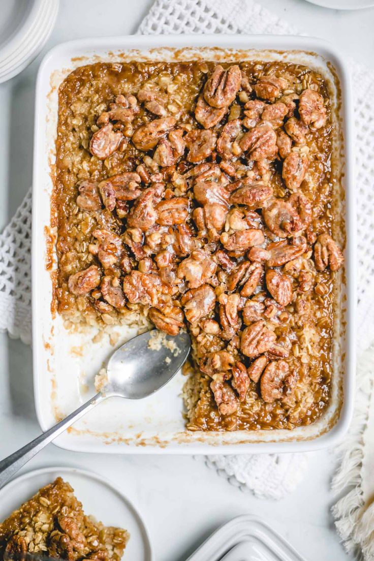 a casserole dish filled with granola and topped with pecans on top