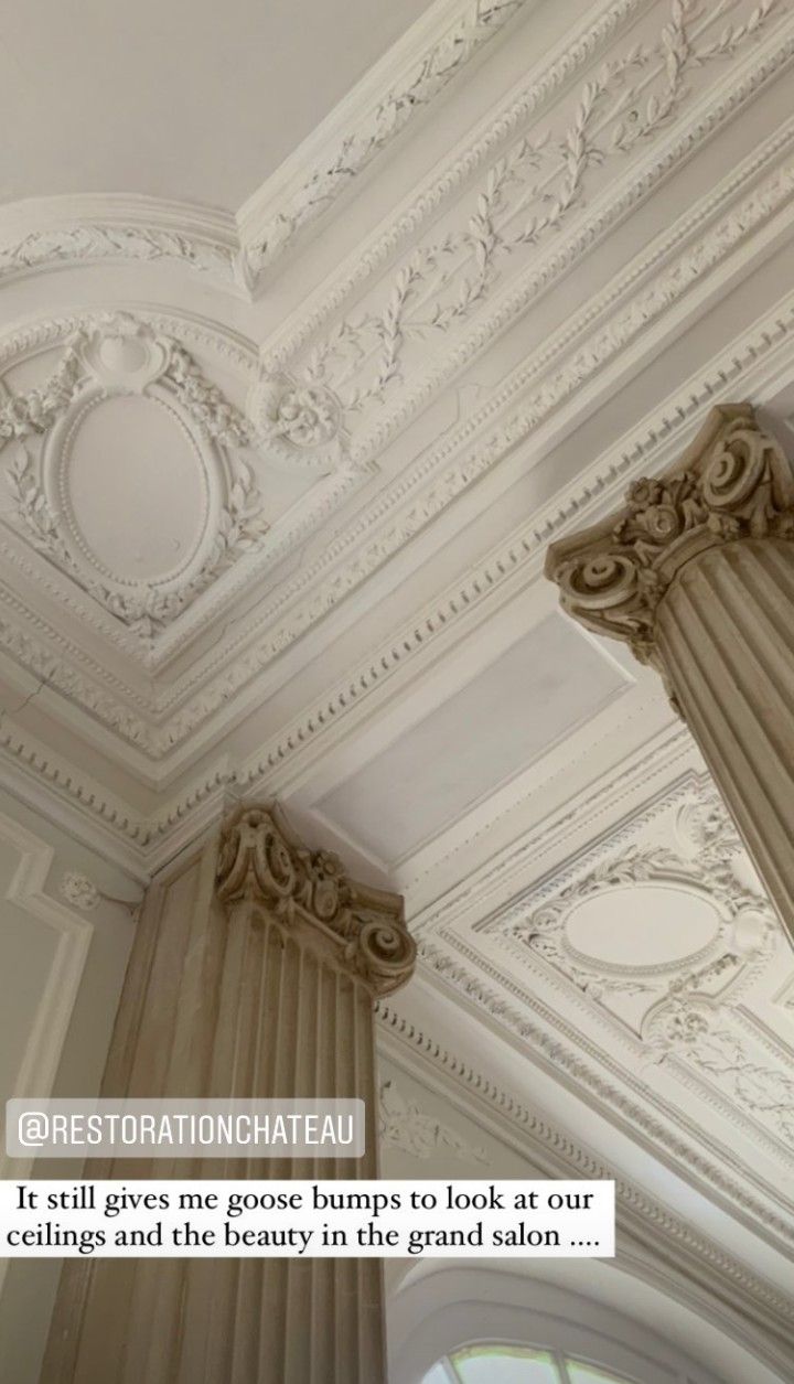 an ornate ceiling with columns and curtains