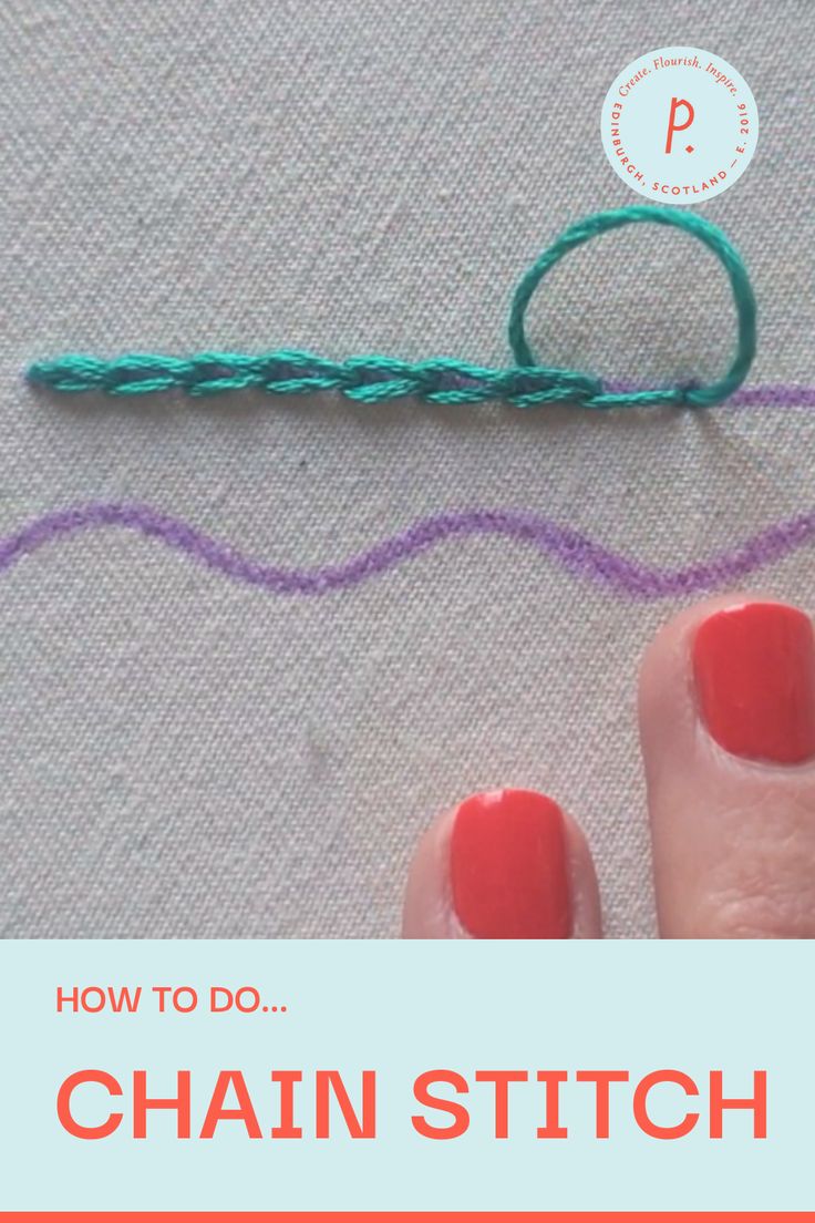 a person's hand with red nail polish next to a green crochet hook