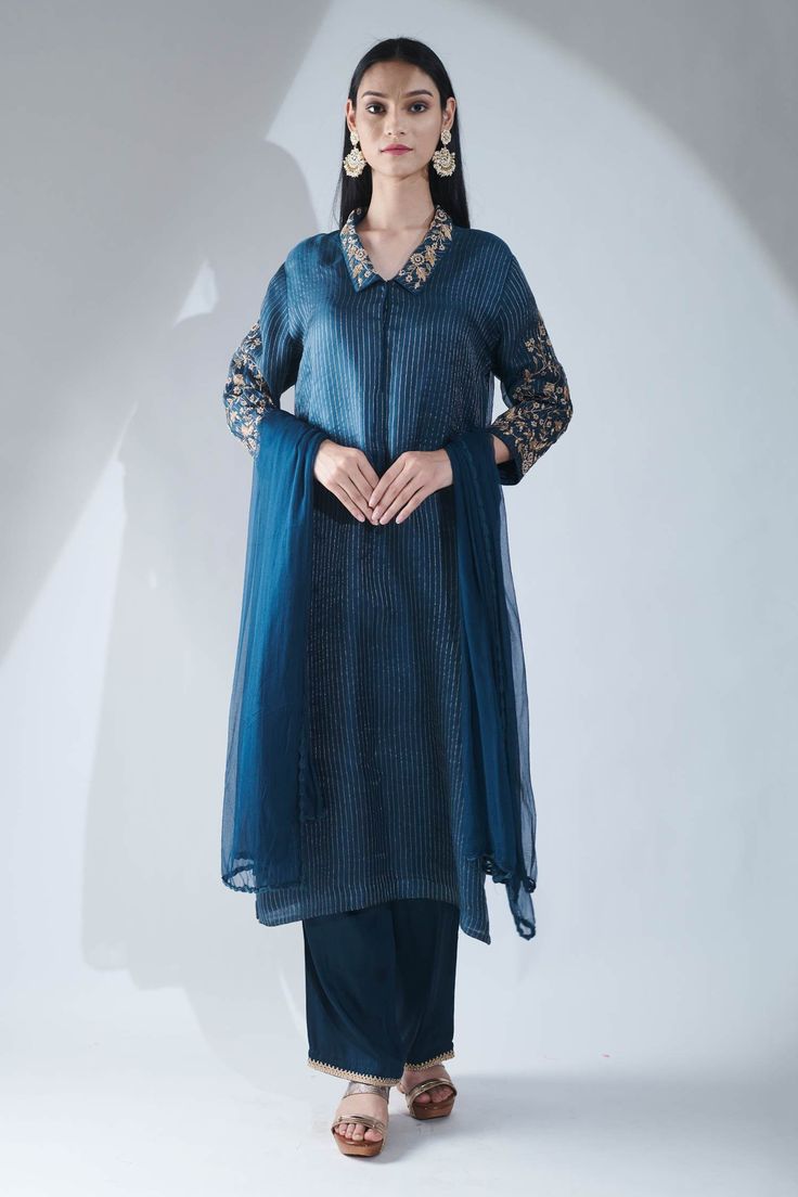 Blue kurta with all-over stripes, floral embroidered collar and sleeves. Comes with satin pant and chiffon dupatta.
Component: 3
Embroidered
Neckline: Collar
Sleeve Length: Full
Fabric: Organza, Chiffon, Modal Satin
Color: Blue
Dori and moti embroidery
Straight kurta
Concealed hook closure placket
Straight fit pant with embroidery at the hem - Aza Fashions Traditional Silk Pant Set For Formal Occasions, Blue Unstitched Pant Set For Eid, Festive Silk Kurta With Embroidered Sleeves, Unstitched Blue Anarkali Set For Formal Occasions, Blue Formal Palazzo Set For Eid, Unstitched Blue Pant Set For Eid, Designer Silk Pant Set With Long Sleeves, Festive Silk Pant Set With Long Sleeves, Elegant Chanderi Pant Set For Eid