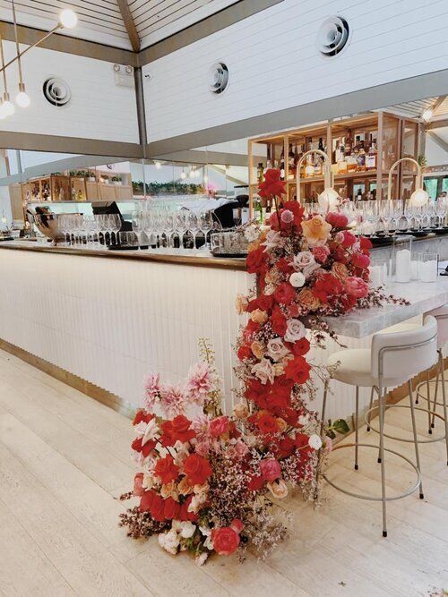 the bar is decorated with red and white flowers