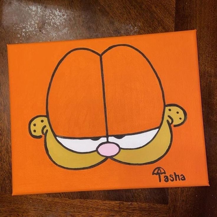 an orange canvas with a cartoon face painted on it