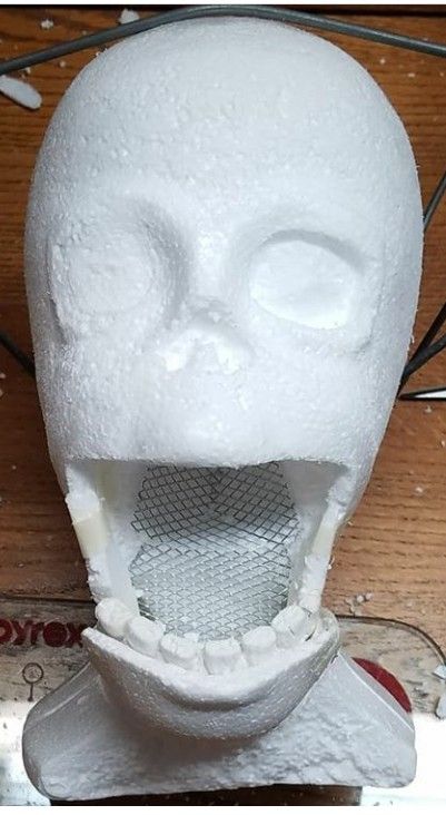 a white plastic head with an open mouth