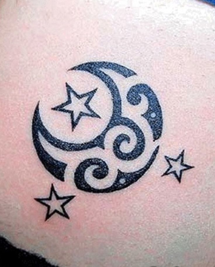 a woman's stomach with stars and crescent tattoo on it