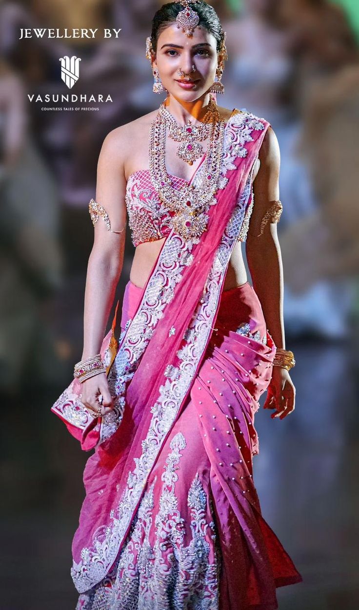 a woman in a pink and white sari