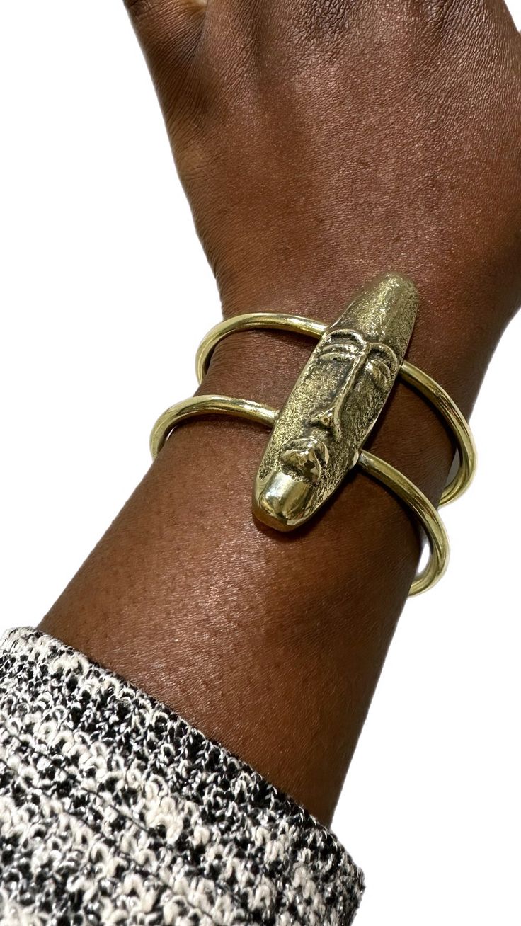 Embrace the heritage and artistry with the African Mask Brass Bracelet This striking piece, handcrafted from genuine brass, features a bold, intricately detailed mask design that evokes the rich cultural symbolism of African art. Short Face, African Inspired Jewelry, African Accessories, Long Face, African Mask, Ear Climbers, Brass Bracelet, African Masks, Jewelry Lookbook