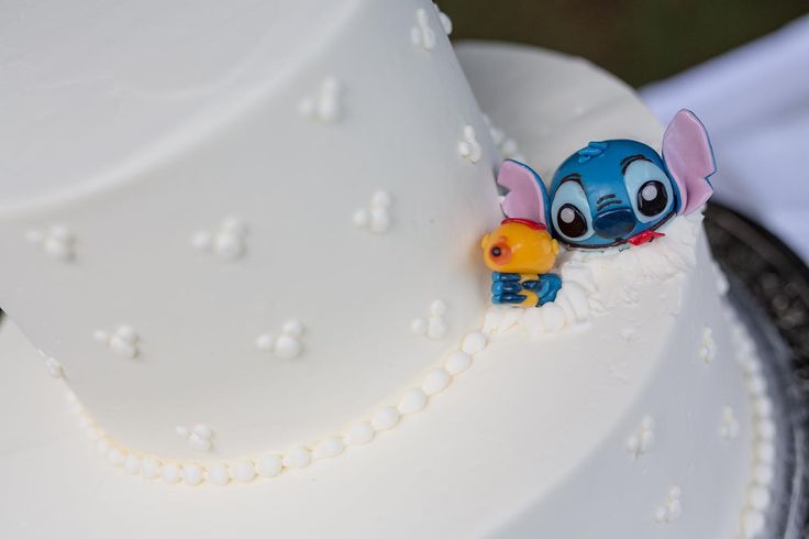 a close up of a white cake with an elephant figurine on the top