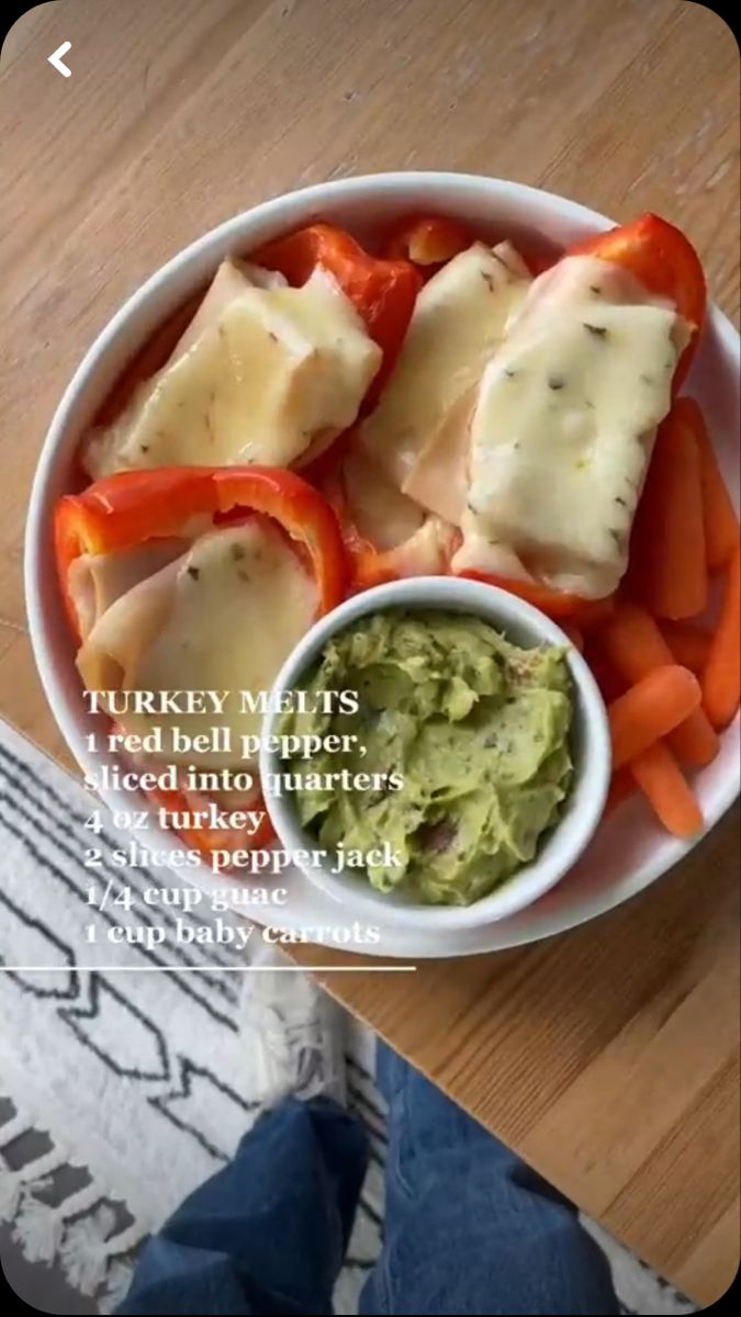 a bowl filled with vegetables and cheese on top of a wooden table next to an instagram page