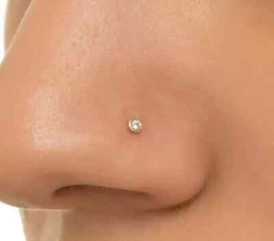 a woman's breast with a single diamond on it