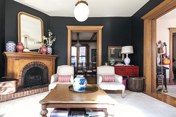 a living room with black walls and white furniture