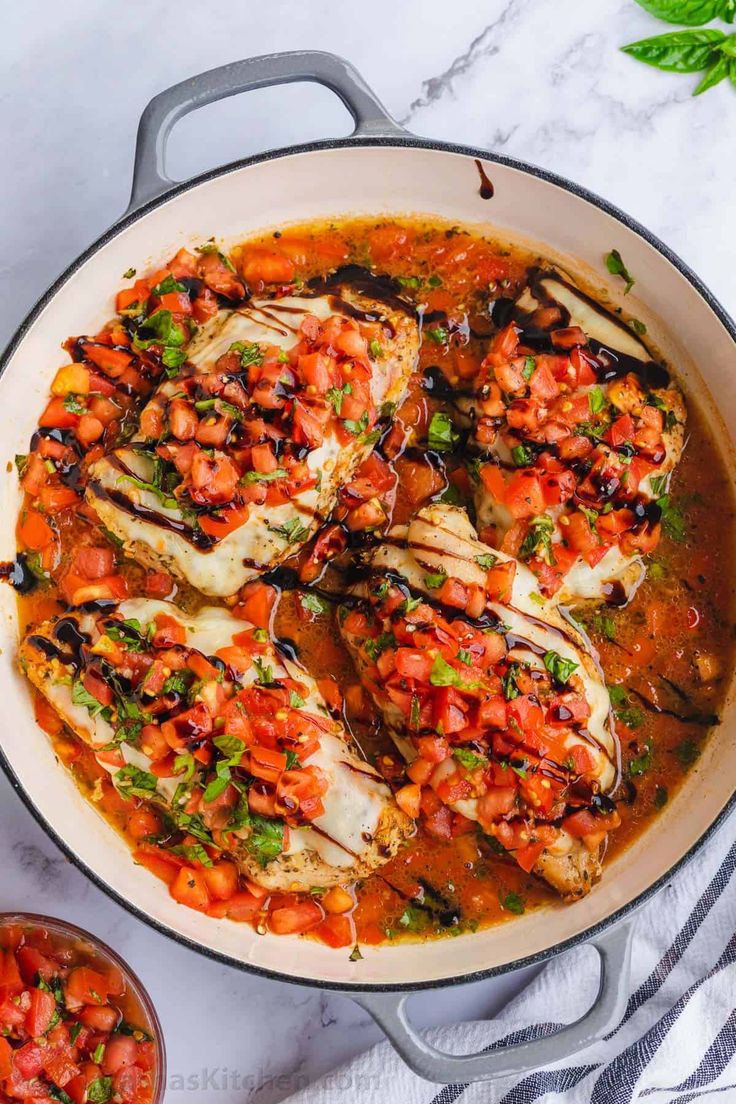 a pan filled with fish covered in tomato sauce