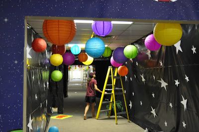 an office hallway decorated with paper lanterns and stars