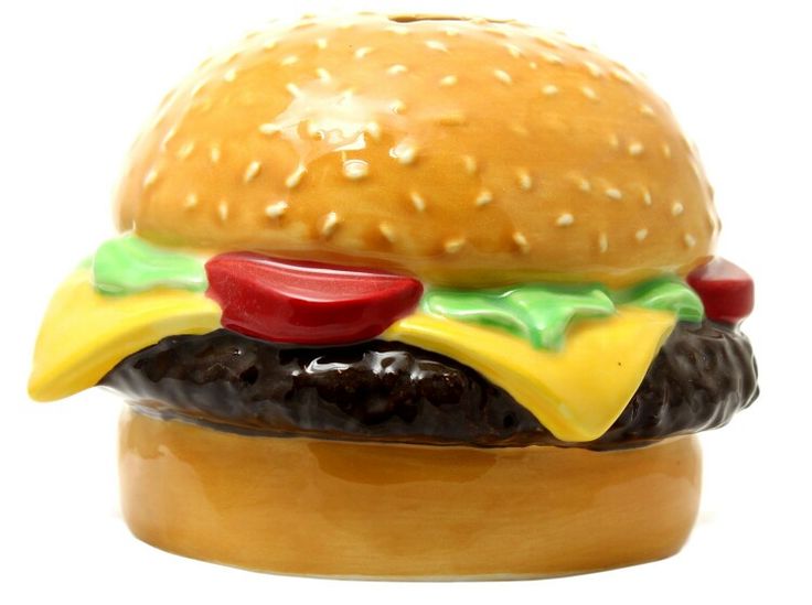 a ceramic hamburger sitting on top of a wooden table