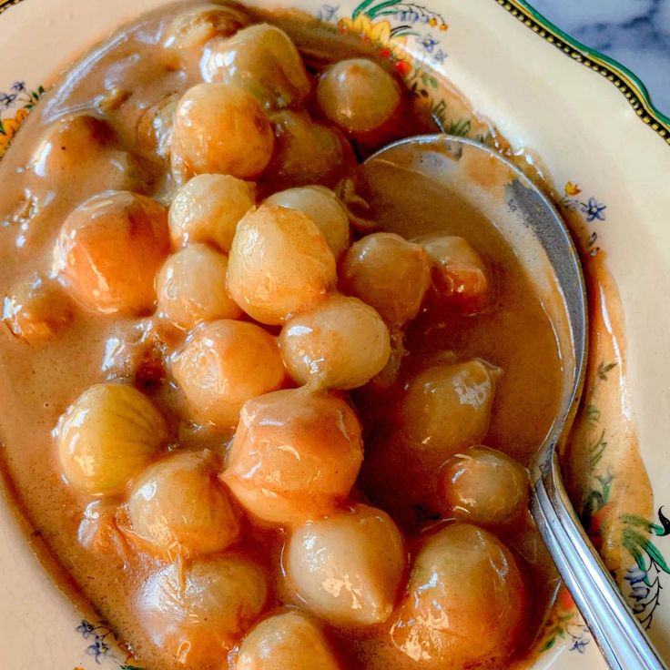 a spoon with some food in it on a plate