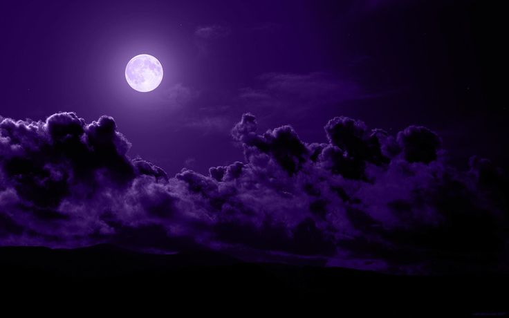 the full moon is shining brightly in the night sky with clouds and dark purple hues