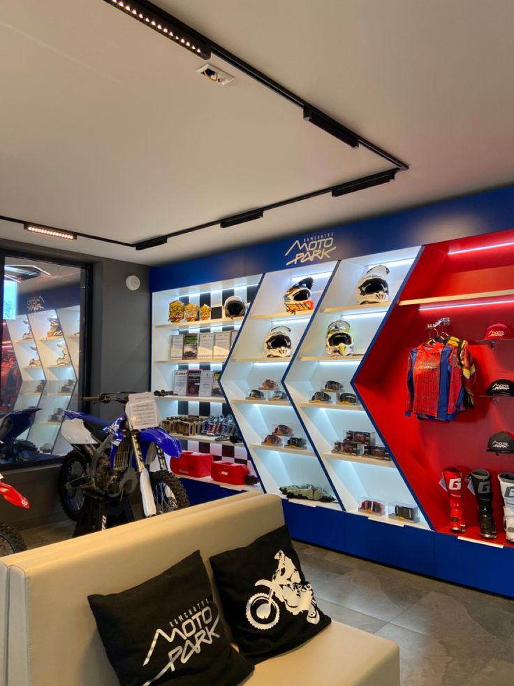 the motorcycle shop is filled with different types of hats and accessories, including helmets on display