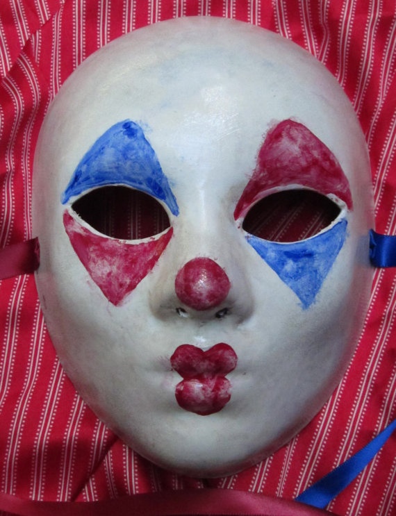 a white mask with blue and red painted on it