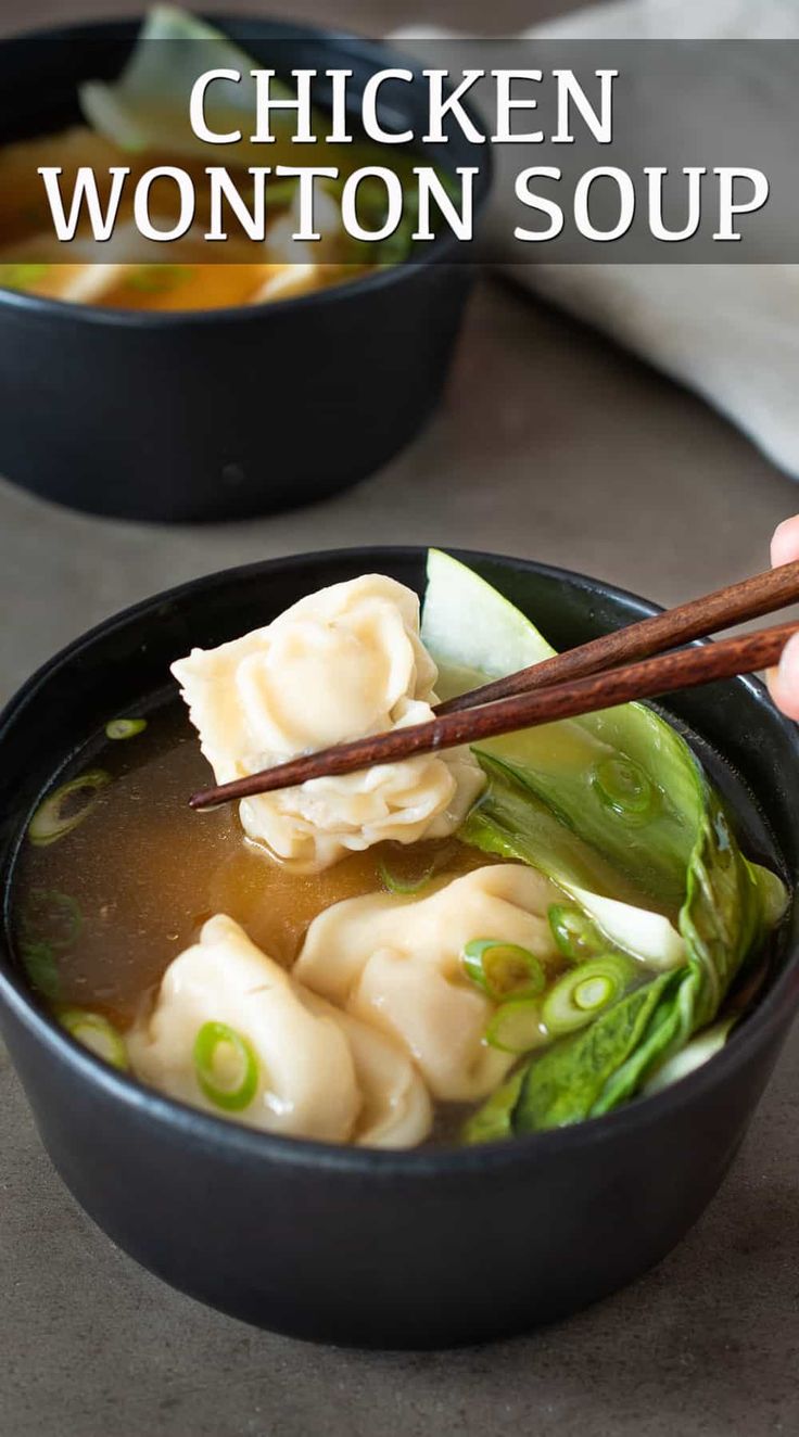 a person holding chopsticks over a bowl of wonton soup