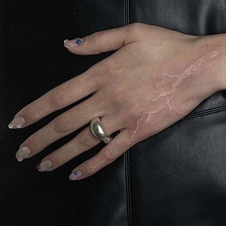 a woman's hand with lightning painted on it