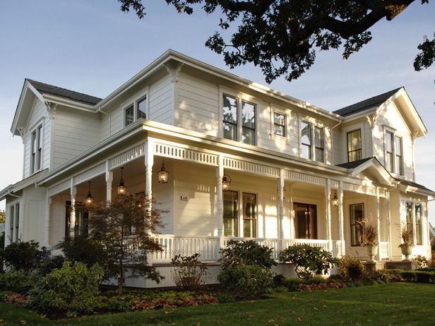 a large white house sitting on top of a lush green field