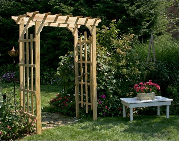 a wooden arbor in the middle of a garden