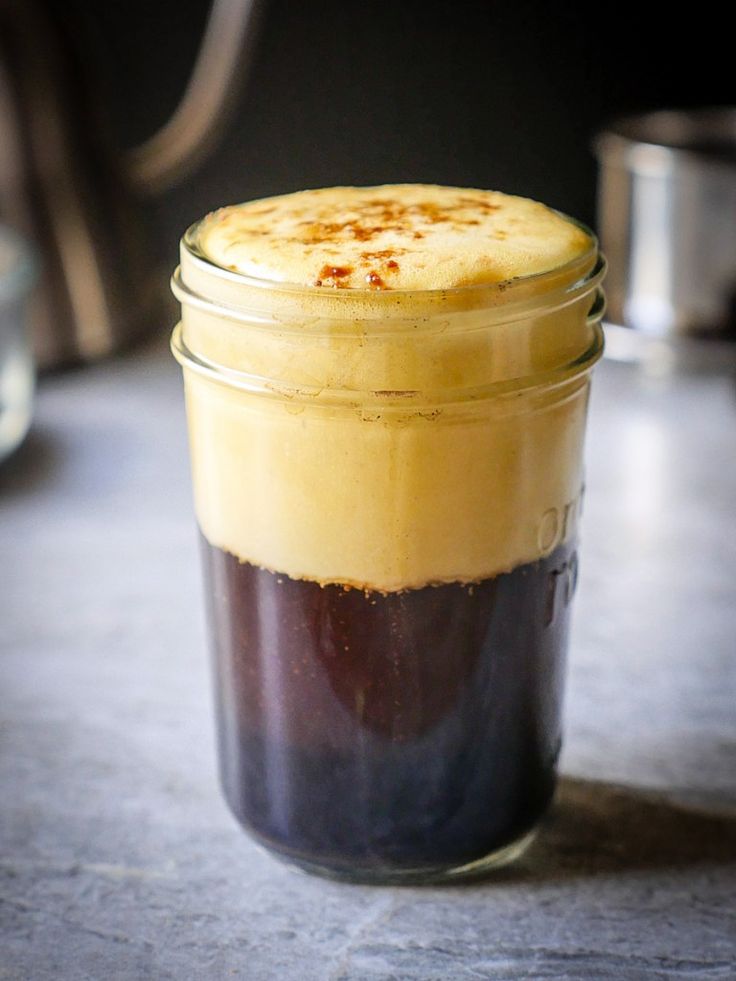 a glass jar filled with food sitting on top of a table