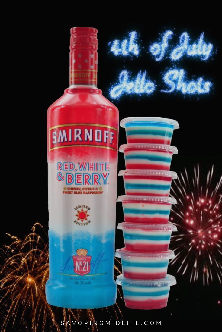 a bottle of vodka next to cups and fireworks