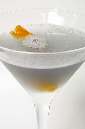 a martini glass with an orange garnish in it