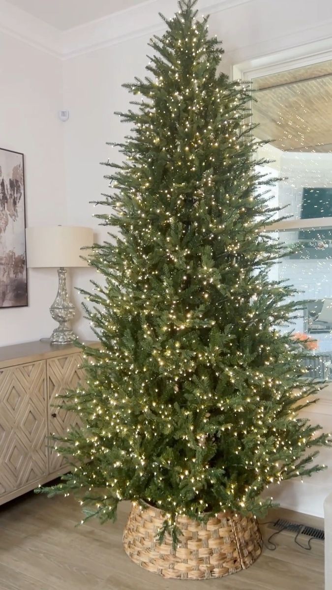 a christmas tree is in a basket on the floor