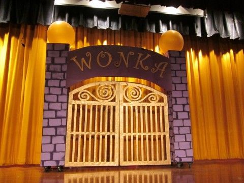 the entrance to wowkids is lit up with yellow lights and draping