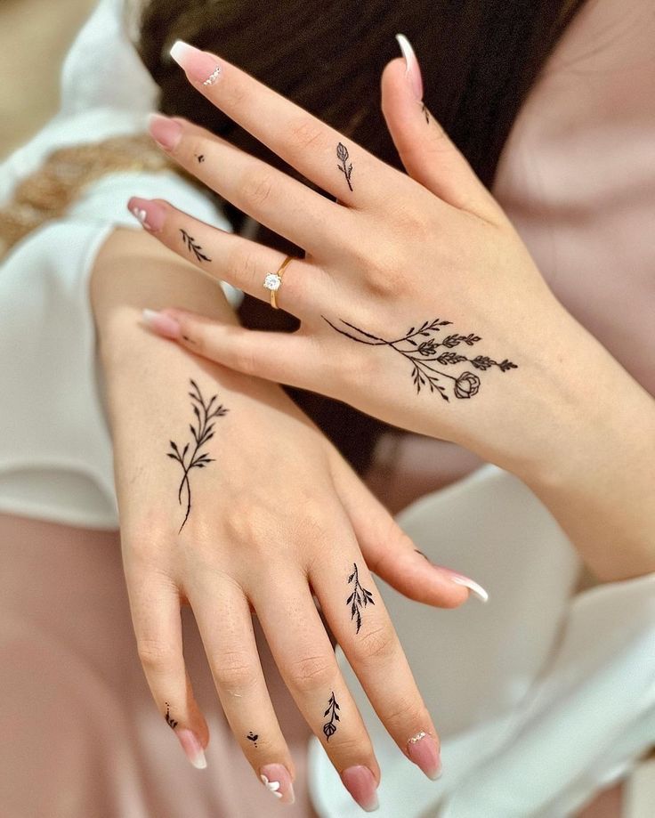 two women with matching tattoos on their hands