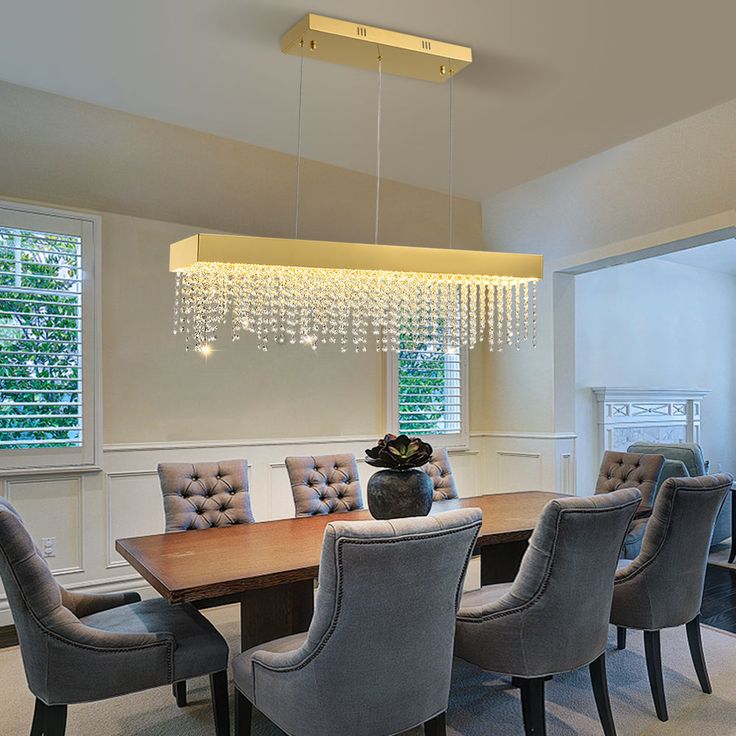 a dining room table with chairs and chandelier