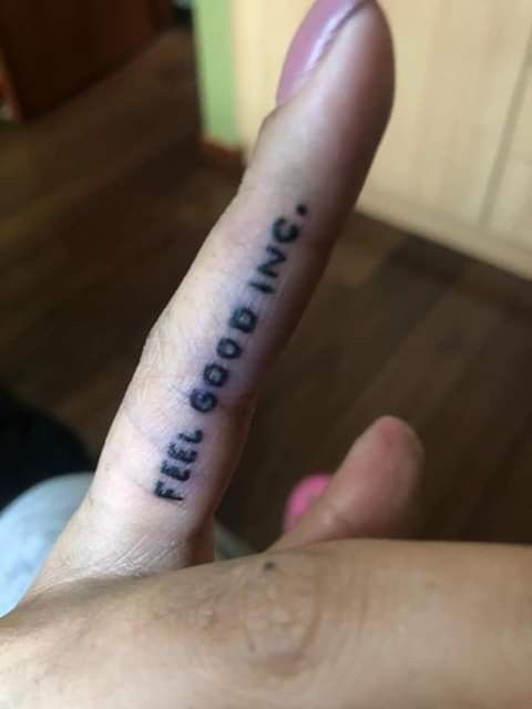 someone is holding their finger up with the words free and dying on it in black ink